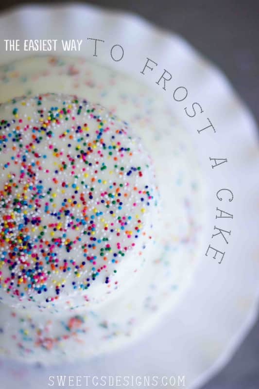 a cake with white frosting and sprinkles