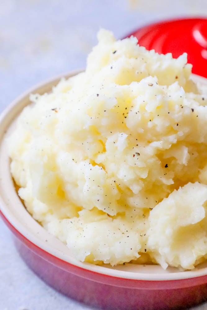 Slow cooker mashed potatoes on a table.
