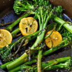 Meyer Lemon slices and Broccolini are being sautéed in a pan.