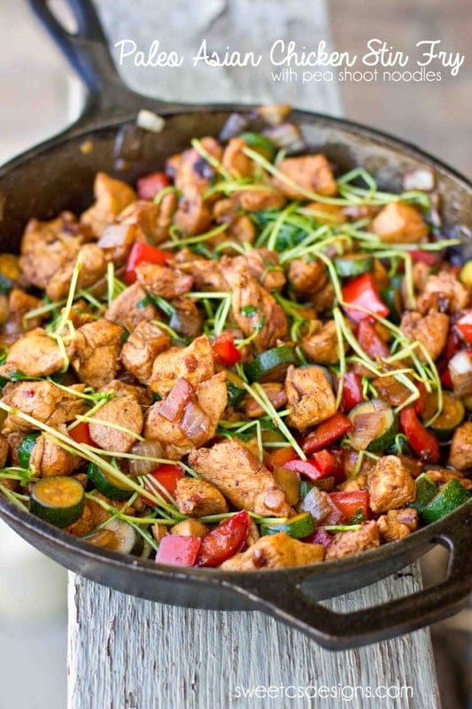 skillet with chicken, bell pepper, zucchini, and sprouts