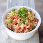 rice with tomatoes and chives on it