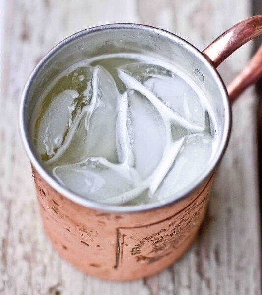 A gin buck in a copper mug filled with ice.