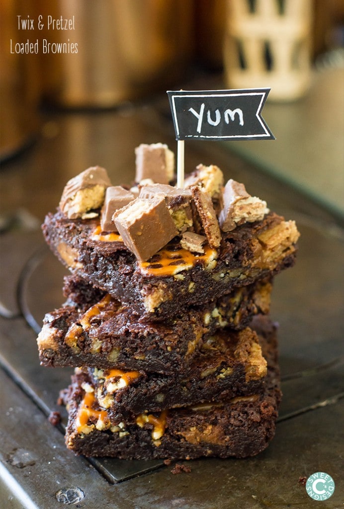 stack of brownies packed with pretzels and twix.