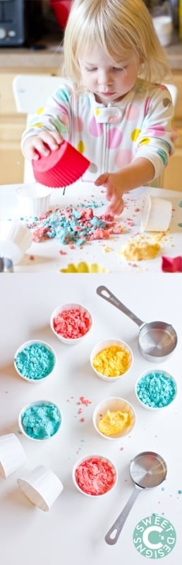 kid playing with moonsand, containers of blue, yellow, and red moon sand