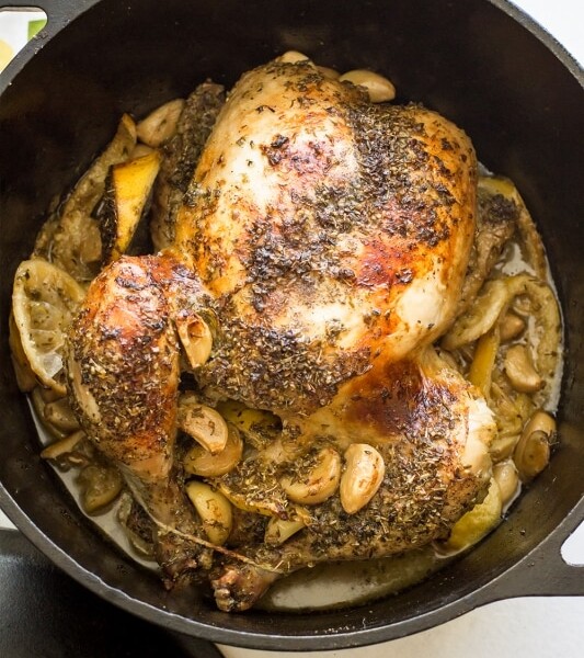 A roasted Greek chicken in a Dutch oven.