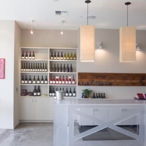 A wine bar featuring the La Crema Healdsburg Tasting Room with lots of bottles on the counter.