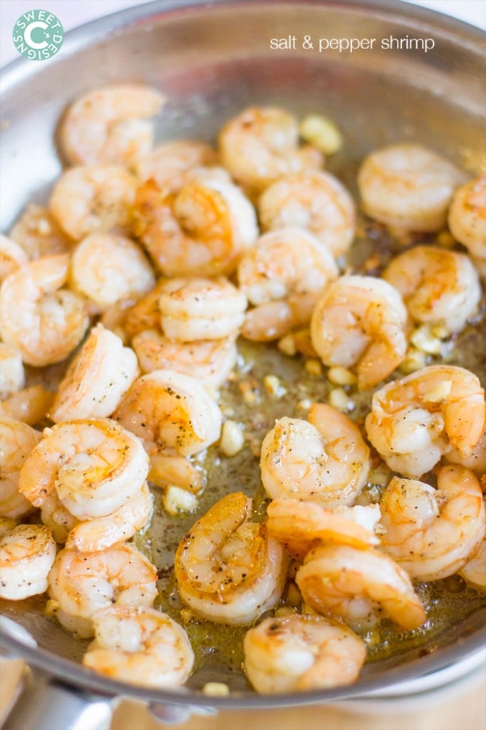 shrimp in a pan with garlic, salt, and pepper