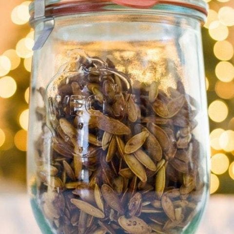 Shattered pistachio seeds in a glass jar.