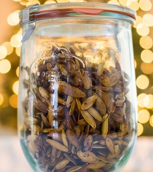 Shattered pistachio seeds in a glass jar.