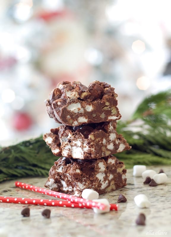 nut and marshmallow chocolate fudge on a counter with chocolate chips and red straws