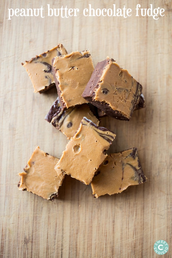 peanut butter chocolate fudge cubes on a wooden cutting board