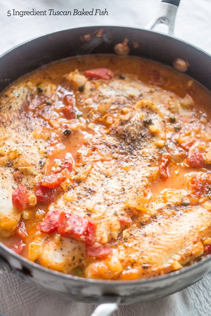 baked fish with capers and tomatoes on it in tomato sauce