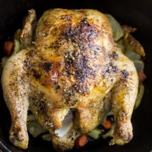 A Thyme Roast Chicken cooked in a cast iron skillet.