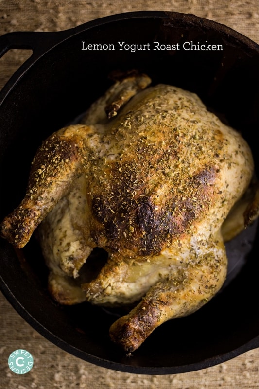 roasted chicken with herbs in a cast iron dutch oven
