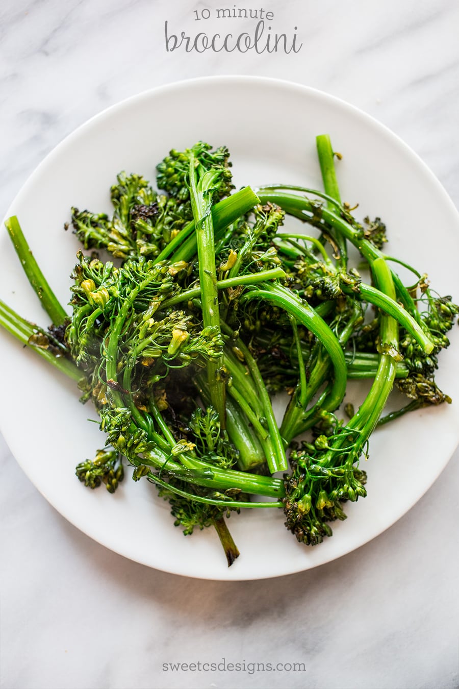 picture of pan fried broccolini on a white plate