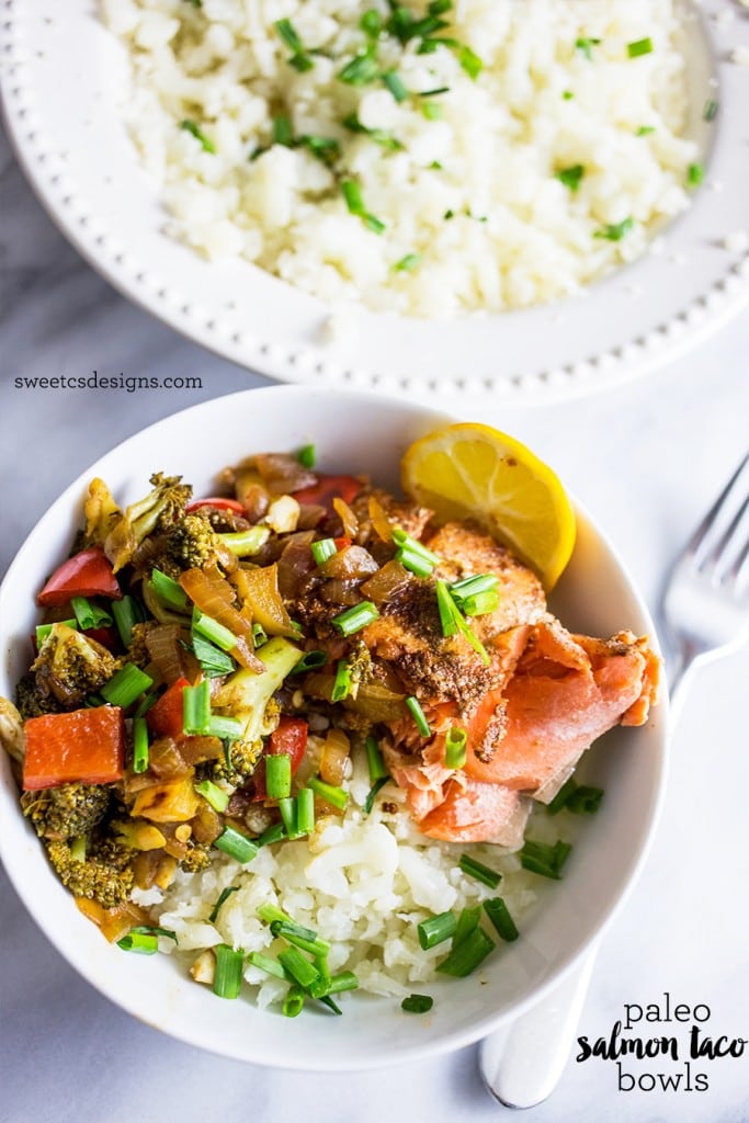 bowl with rice, salmon, broccoli, chives, and lemon in it