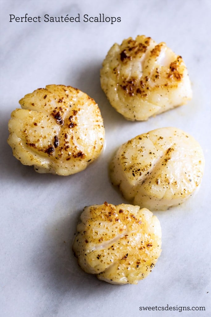 four perfectly seared scallops