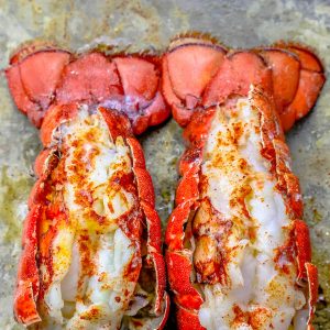 The Best Easy Broiled Lobster Tails Recipe features two lobsters sitting on a baking sheet.