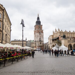 Krakow Main Square featuring a clock tower in the background.