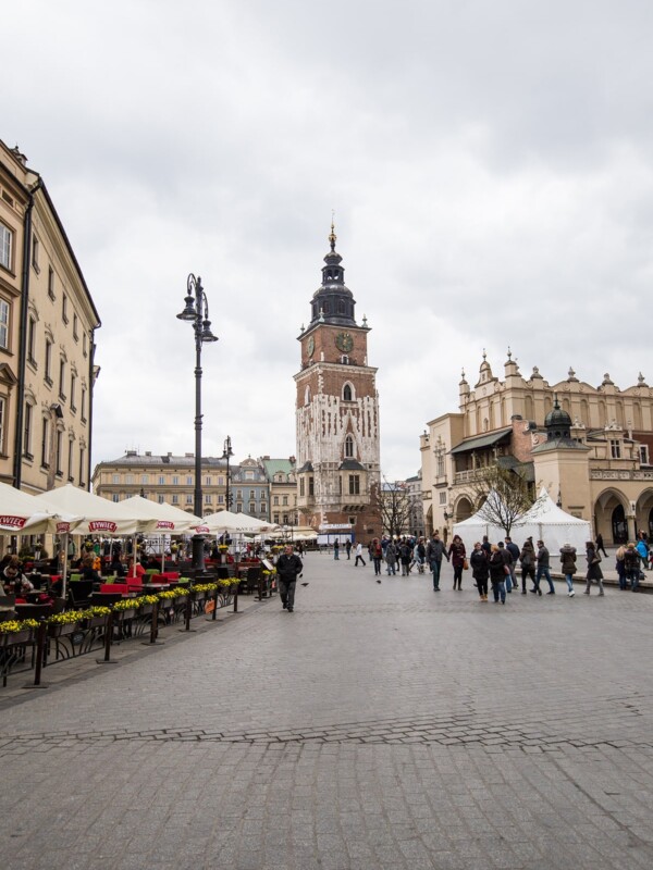 Krakow Main Square featuring a clock tower in the background.