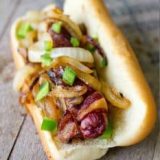 Best Jalapeno Onion Bacon Hot Dogs on a rustic table.