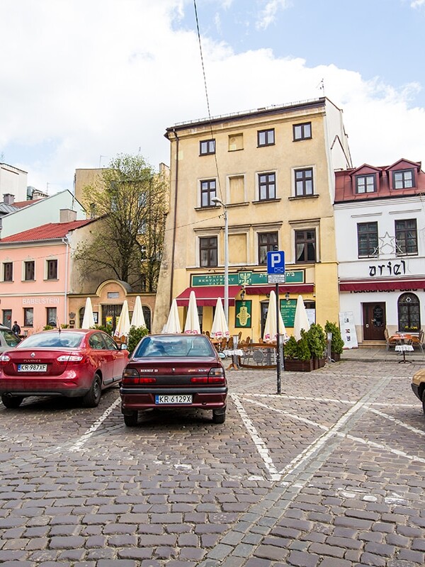 Two cars parked in Touring Kazimierz, Krakow's Jewish District.