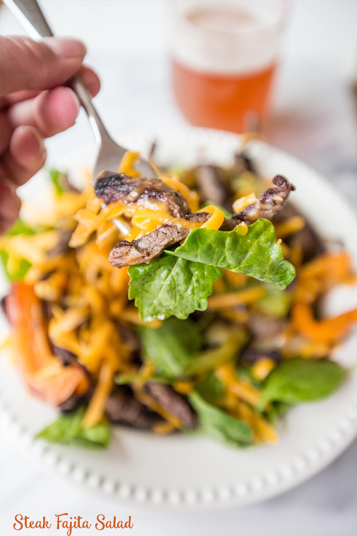 salad with grilled peppers, steak, and cheese