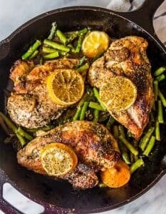 Easy one pot lemon chicken and asparagus cooked in a cast iron skillet.