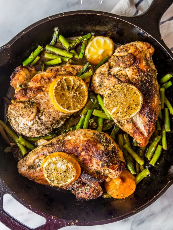 One pot lemon chicken and asparagus in a skillet.