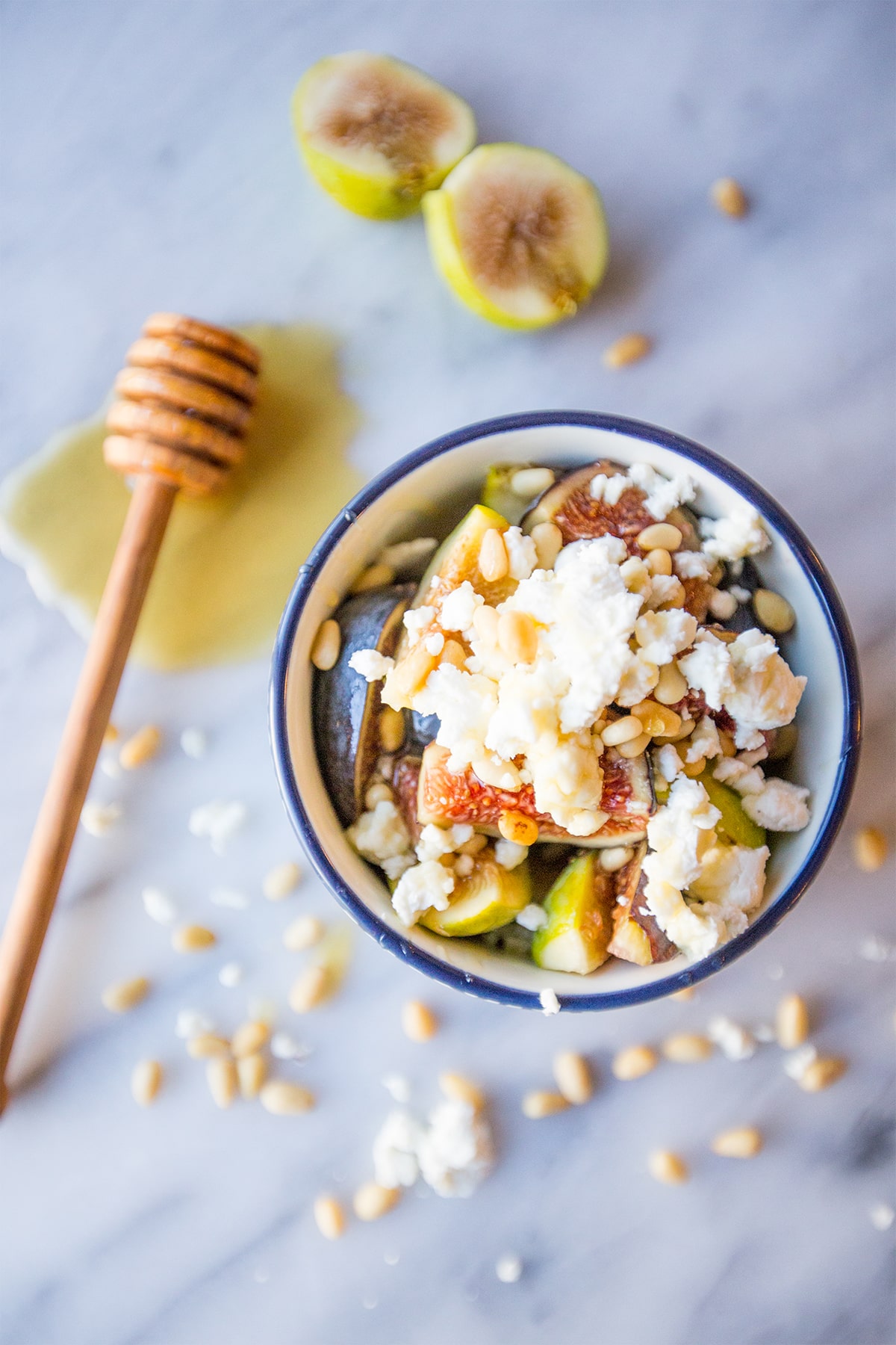 bowl with figs, crumbled cheese, and pine nuts