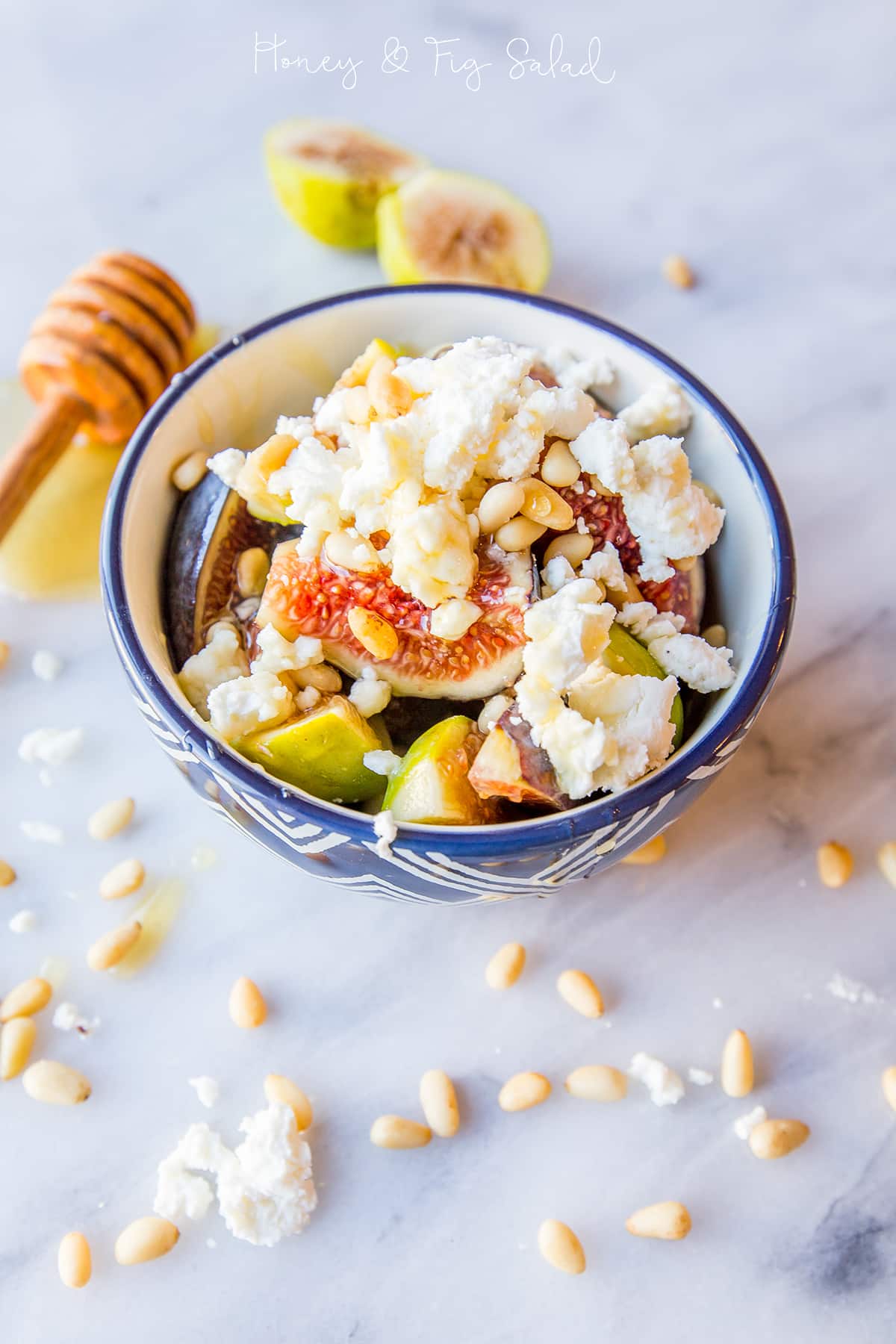 bowl with figs, crumbled cheese, and pine nuts