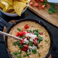 Green Chile Skillet Queso dip with tortilla chips.