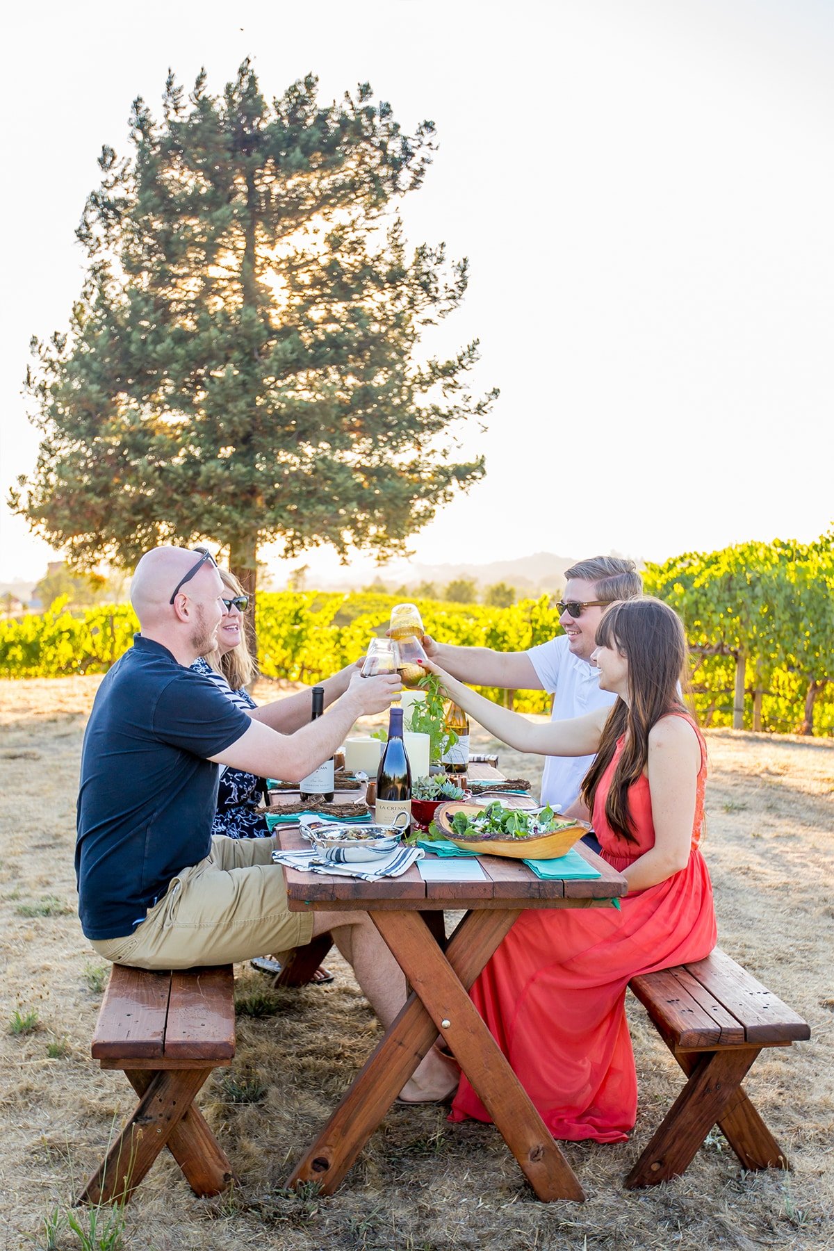 four people around a table cheering