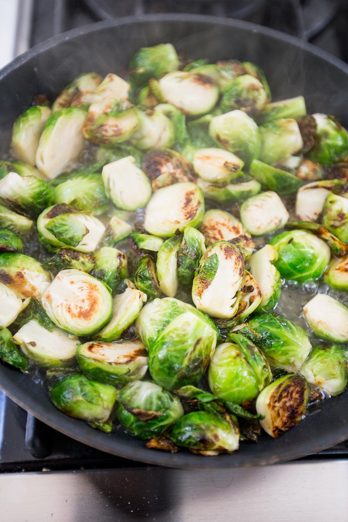 brussels sprouts in a pan cooking