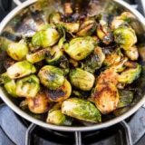 Pan fried brussels sprouts with ghee on the stove.