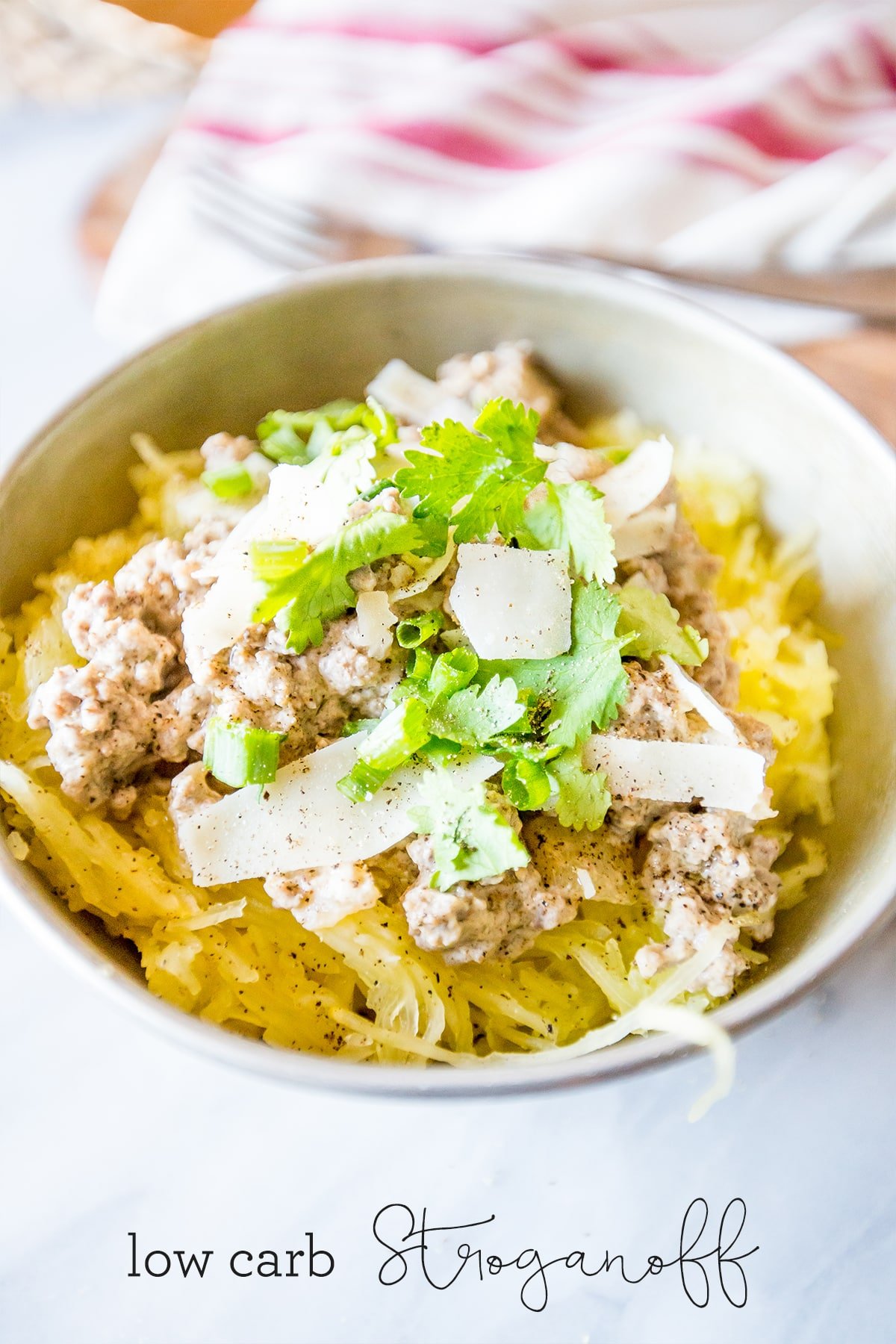 bowl of spaghetti squash with beef stroganoff, parmesan cheese and green onions. 