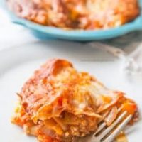 Lasagna casserole on a plate with a fork.