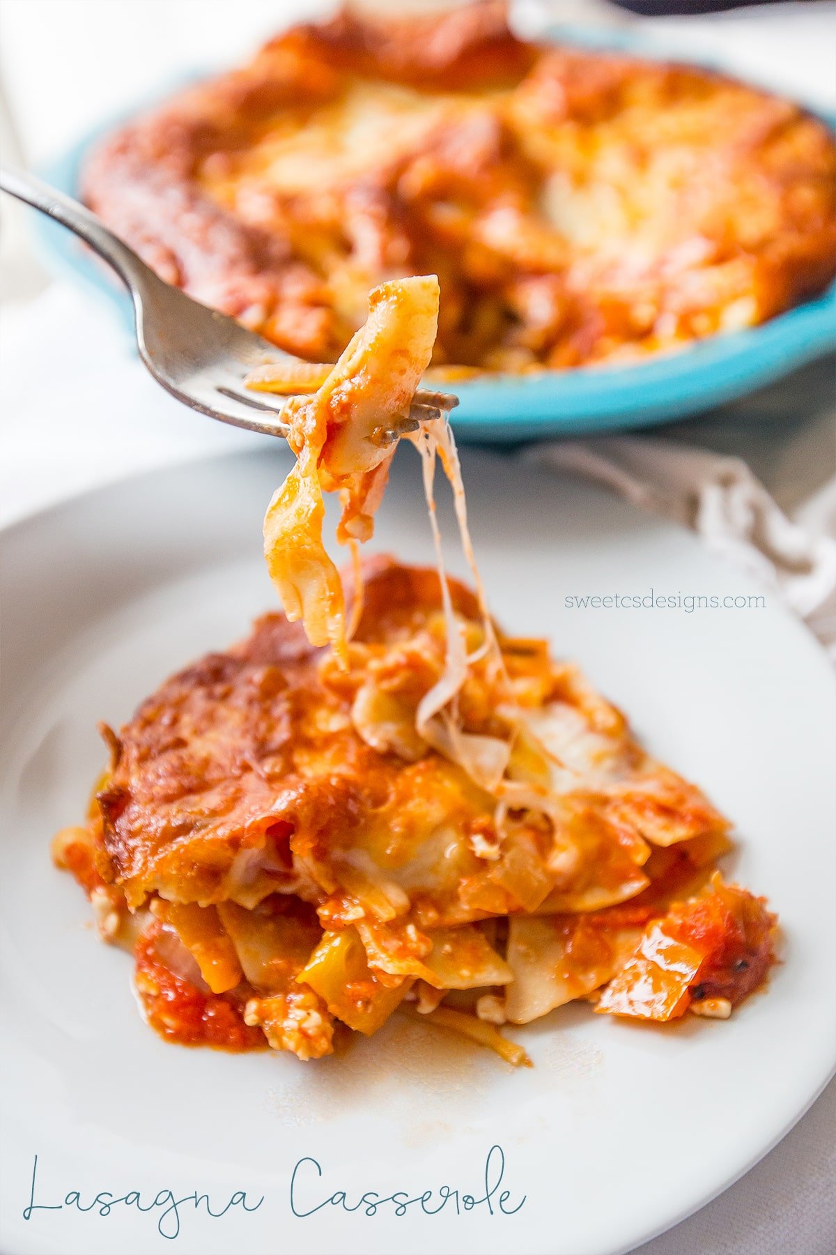 lasagna noodles, cheese, vegetables, and meat layered on a plate with a fork