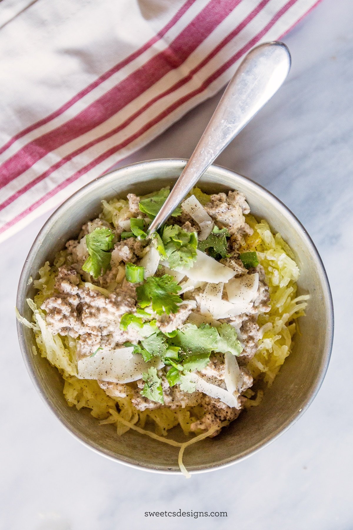 bowl of spaghetti squash with beef stroganoff, parmesan cheese and green onions. 