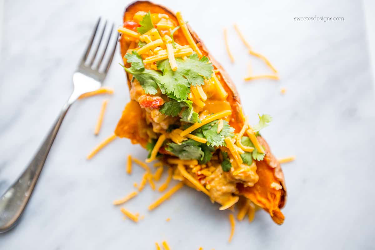 sweet potato with cheese and cilantro on it