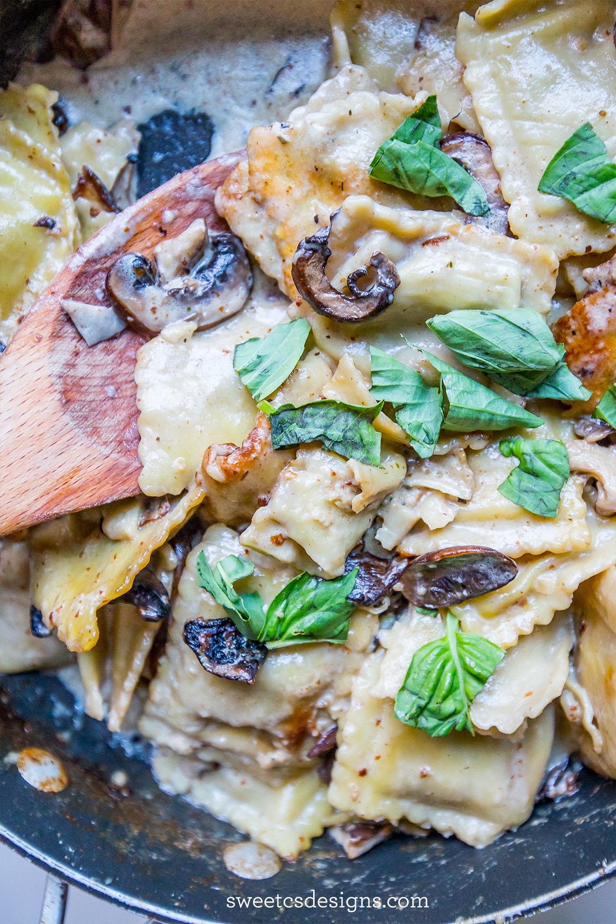 raviolis with basil and mushrooms in a pot