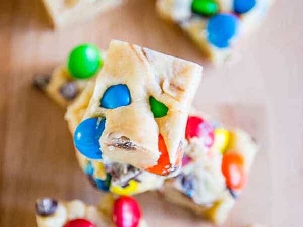 M&m bars with an easy fudge recipe on a cutting board.