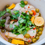 A flavorful One Pot Chicken and Sausage with Olives dish combines tender chicken pieces, savory sausage, briny olives, zesty lemon wedges, and fragrant herbs all in one bowl.