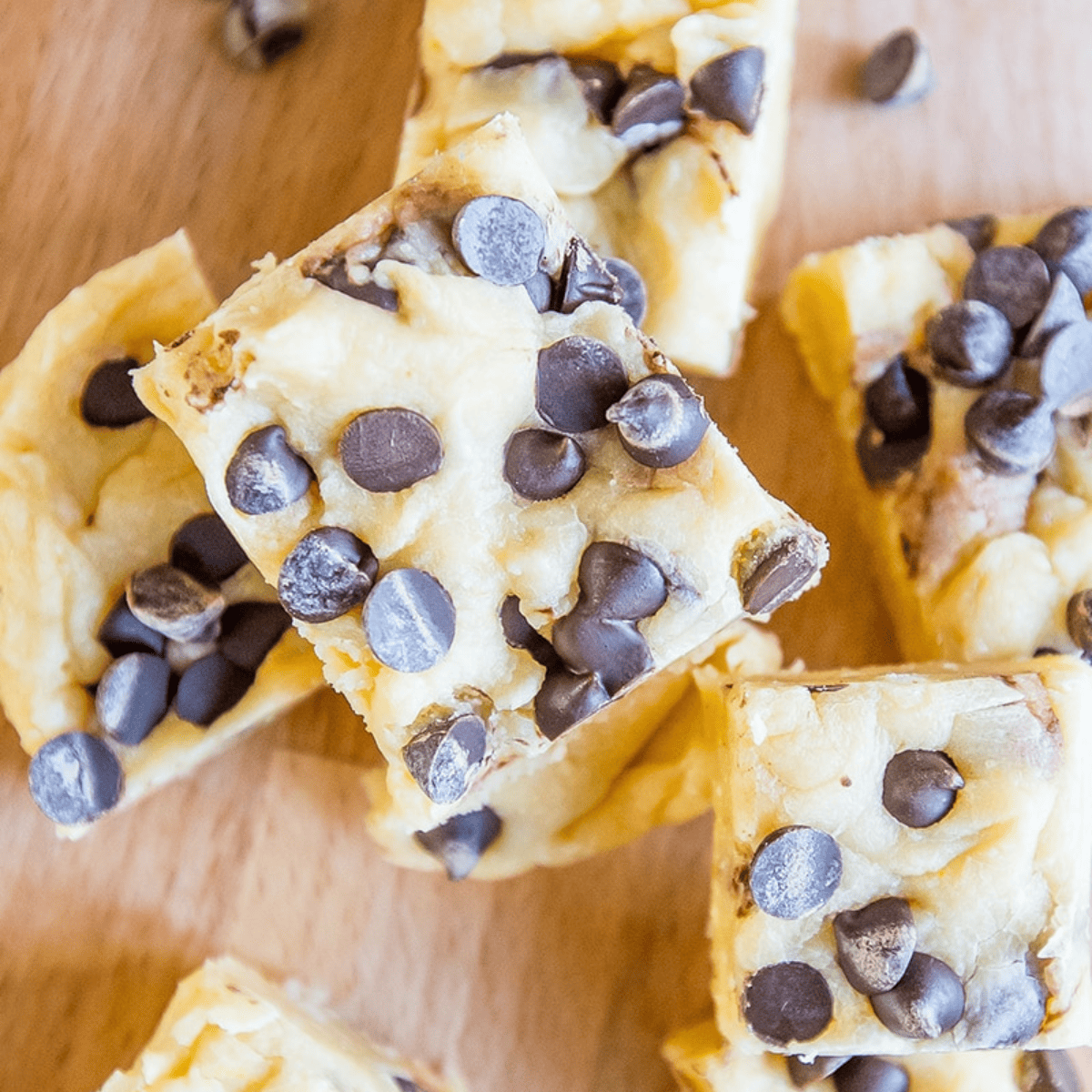 A group of brownies with chocolate chip cookie dough fudge on top.