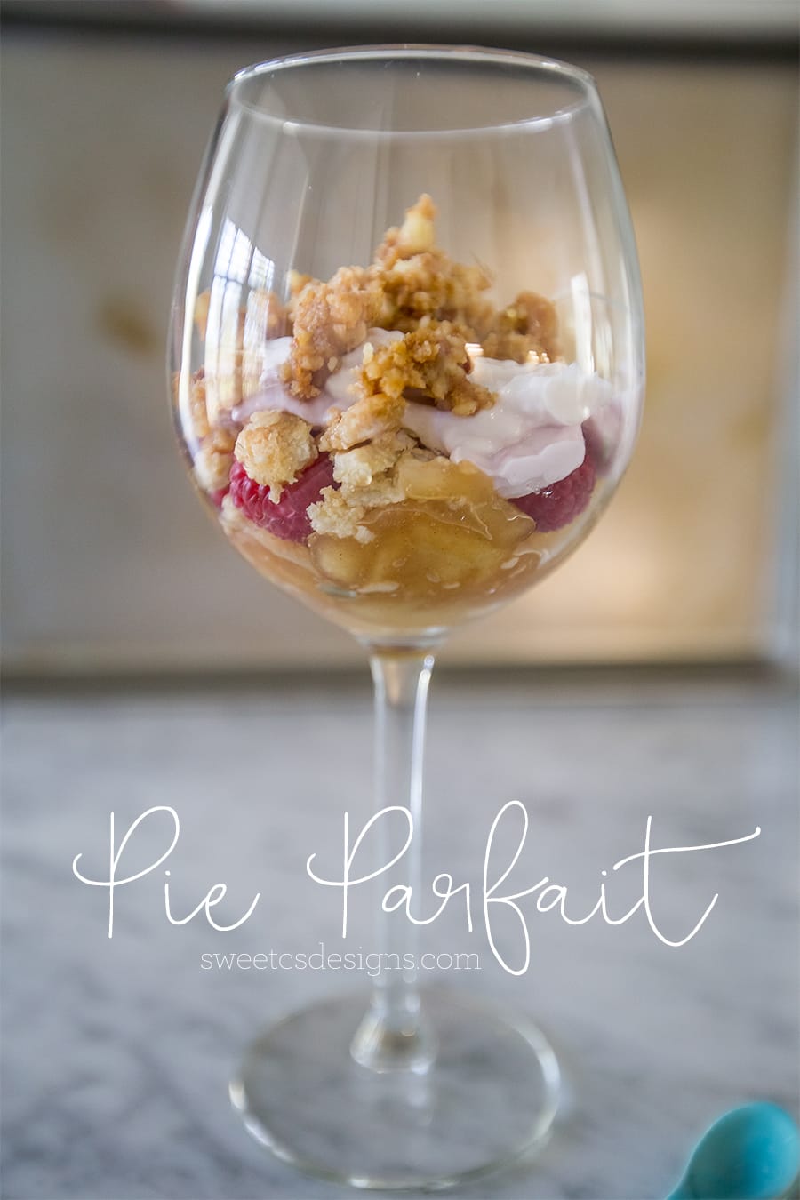 picture of leftovers in a wine glass with yogurt and granola clusters.