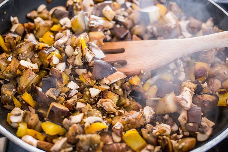 mushrooms being sauteed in a pan