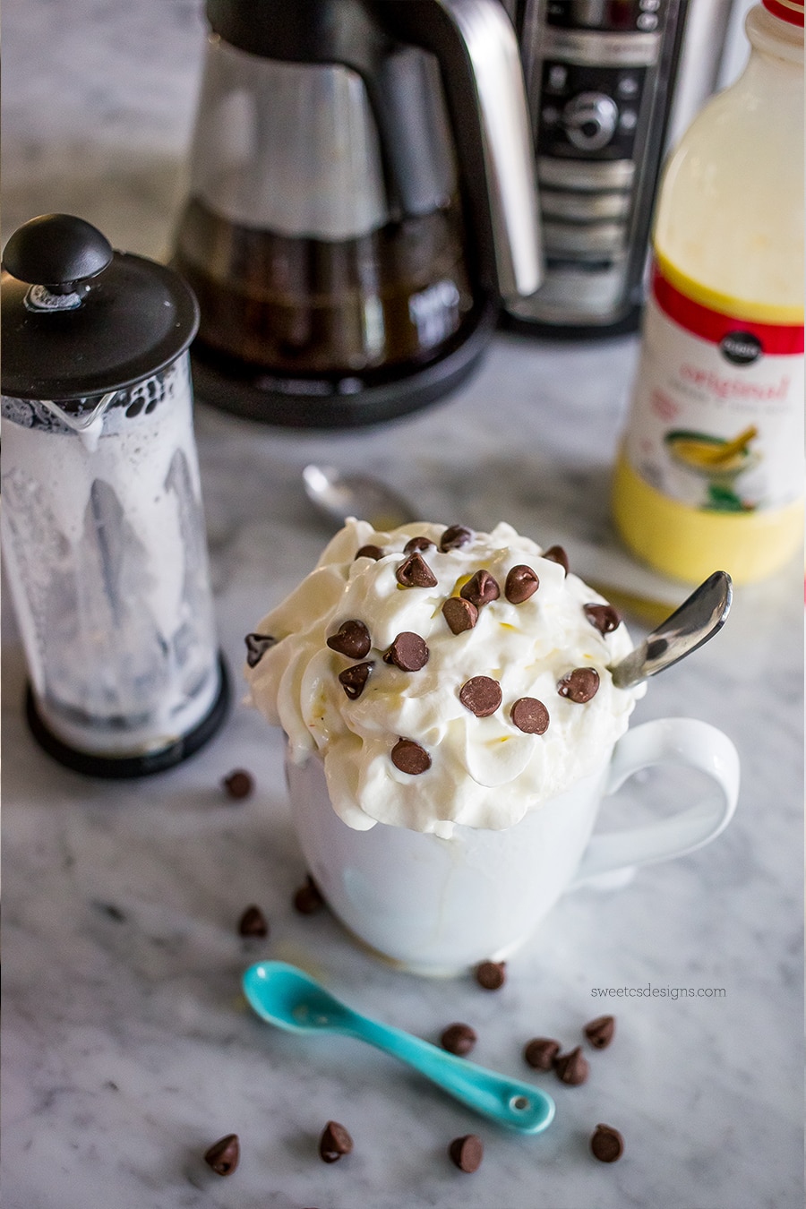 drink in a white mug with whipped cream and chocolate chips