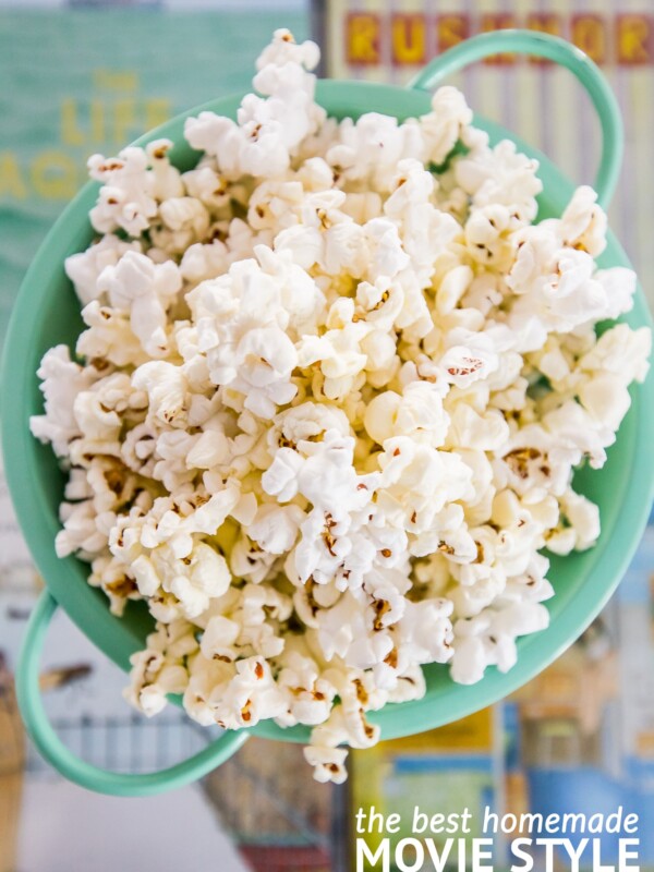 Homemade movie-style butter popcorn in a green bowl.