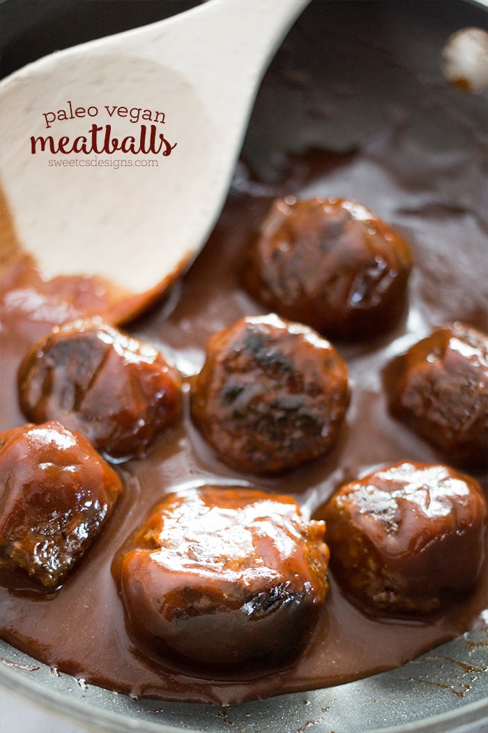 meatballs in bbq sauce in a pot with a wooden spoon
