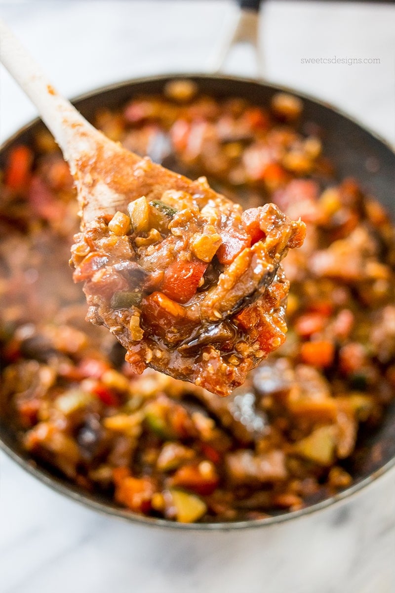 skillet with sauteed vegetables, eggplant, zucchini, tomato, and chickpeas